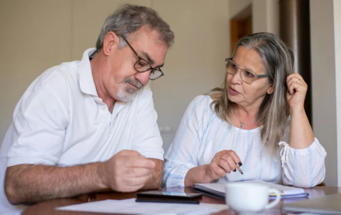Family reviewing monthly bills while considering mortgage forbearance due to financial pressure
