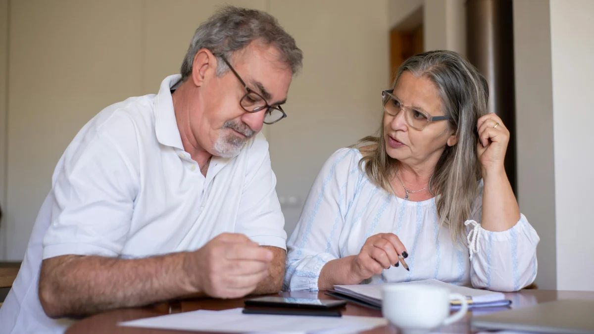 Family reviewing monthly bills while considering mortgage forbearance due to financial pressure