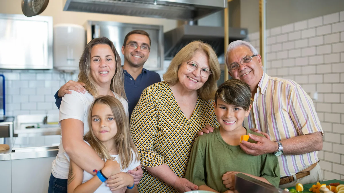 Family discussing finances at kitchen table while considering mortgage forbearance for temporary payment relief