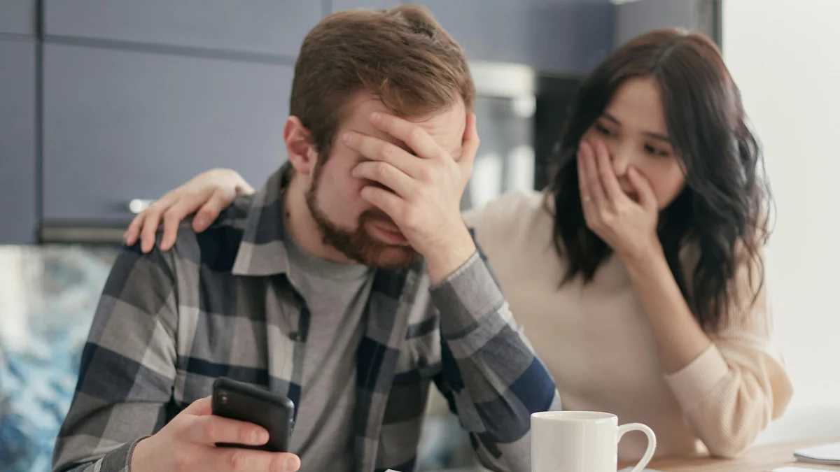 Stressed homeowner looking at bills and exploring mortgage forbearance to manage overwhelming mortgage payments